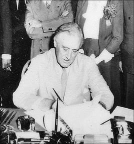 FDR signing the GI Bill into law